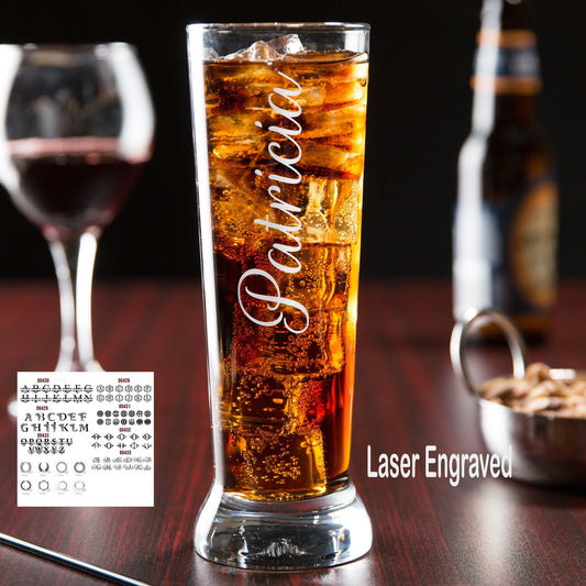 Custom engraved pilsner glass with laurel wreath monogram and name, filled with beer