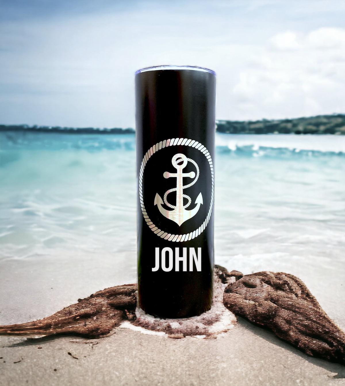 Laser-engraved monogram and anchor design on a stainless steel tumbler.