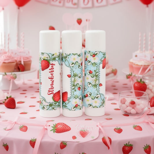 Close-up of strawberry party favor stickers arranged together, featuring glossy wrap-around label sheets.