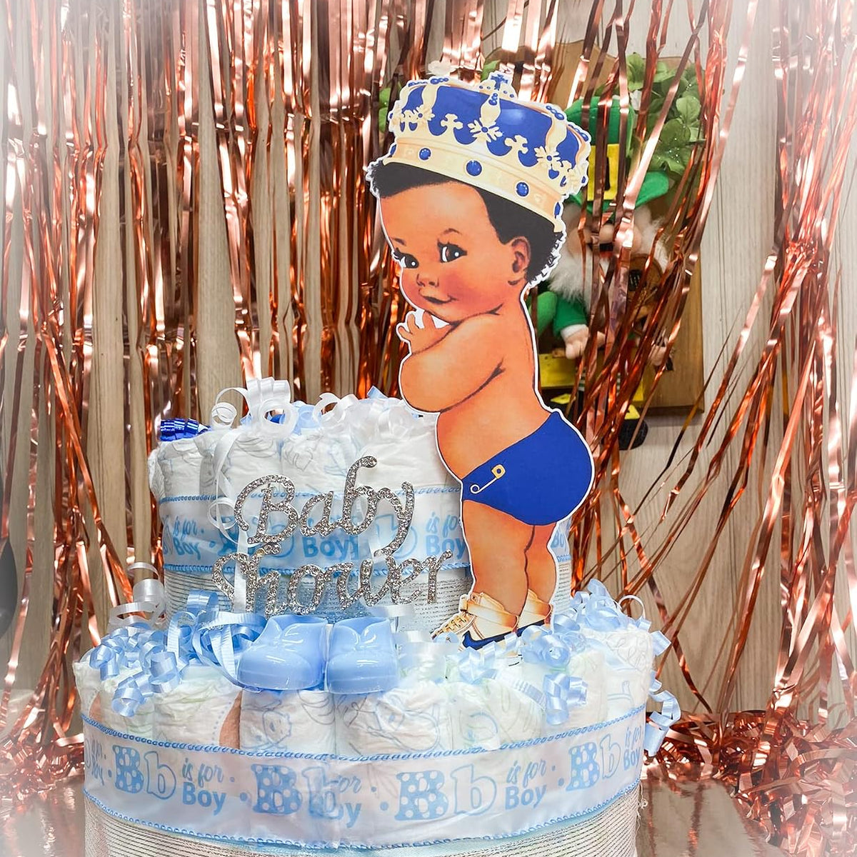 Royal blue baby prince centerpiece on a diaper cake for a boy baby shower