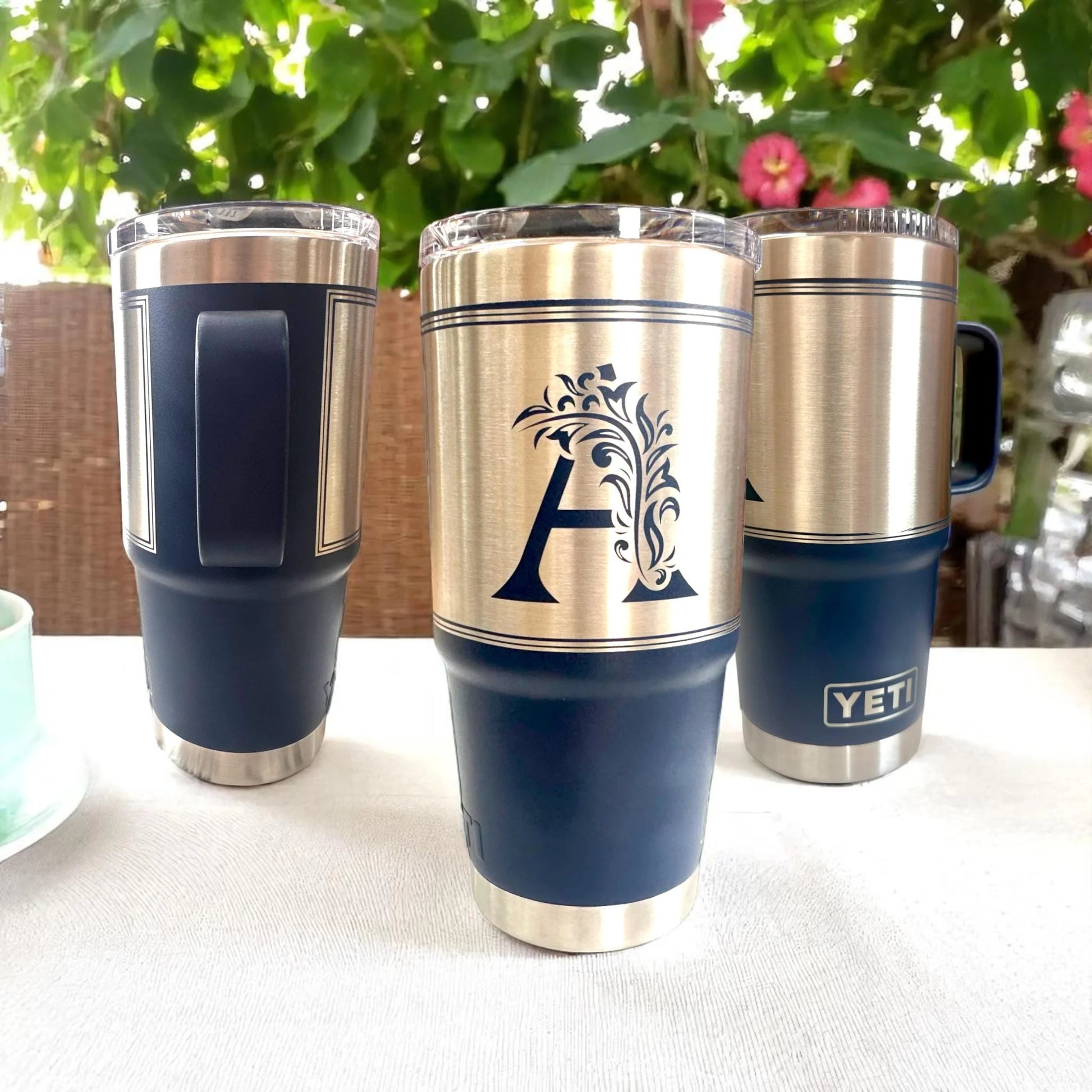  YETI tumblers with decorative design and 'A' logo on a white surface 
