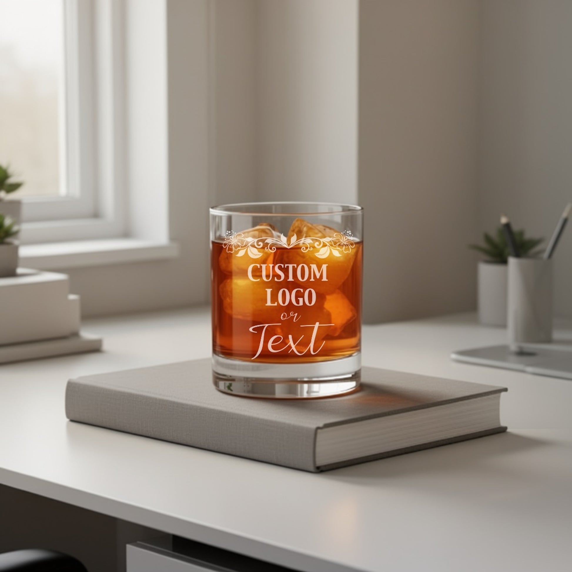Close-up of several bulk custom whiskey glasses with different company logos, ready for events.