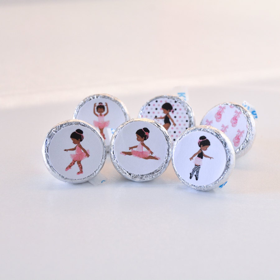 Detailed shot of round stickers featuring an African American girl dancer in a pink tutu on a matte background.