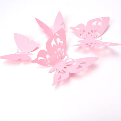 Assortment of pink paper butterflies with optional adhesive tabs, ready for party or nursery wall decoration setup.