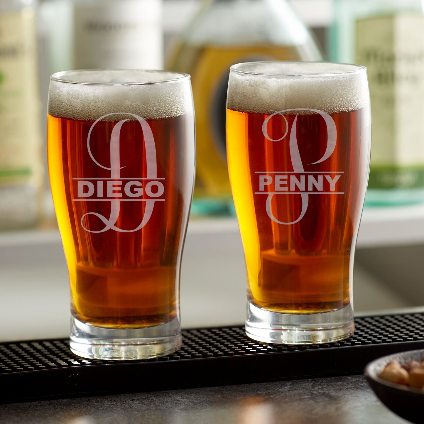 Close-up of a laser-engraved pub glass showcasing a detailed custom logo or design on clear glass.