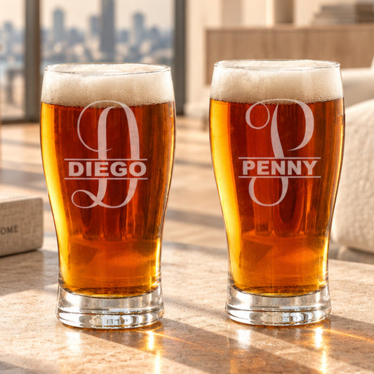 Close-up of a laser-engraved pub glass showcasing a detailed custom logo or design on clear glass.