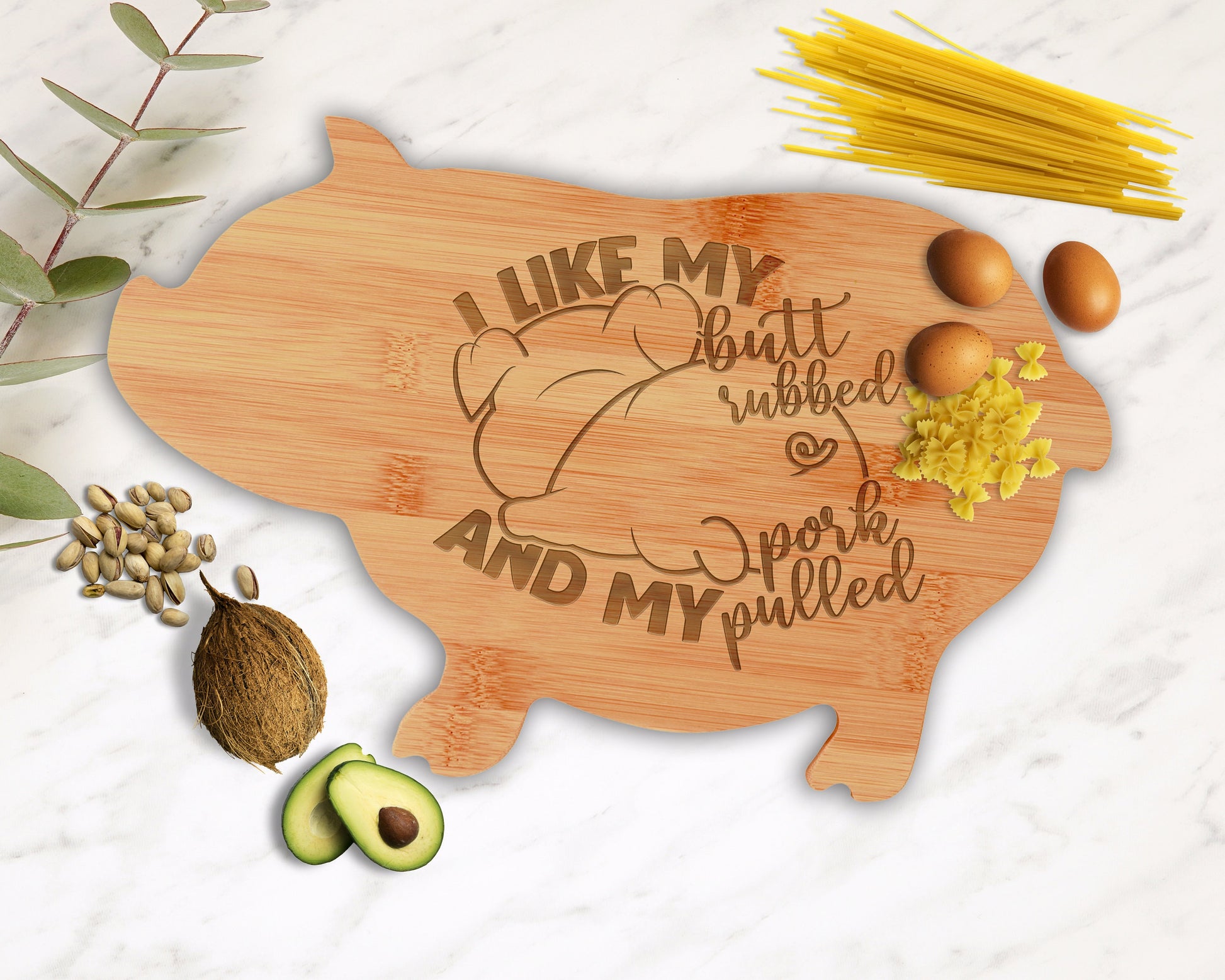 Engraved bamboo pig cutting board with a sample logo, presented as a kitchen gift.