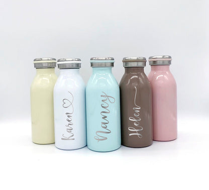 Pastel personalized water bottle styled on a desk showing the durable laser-etched design.