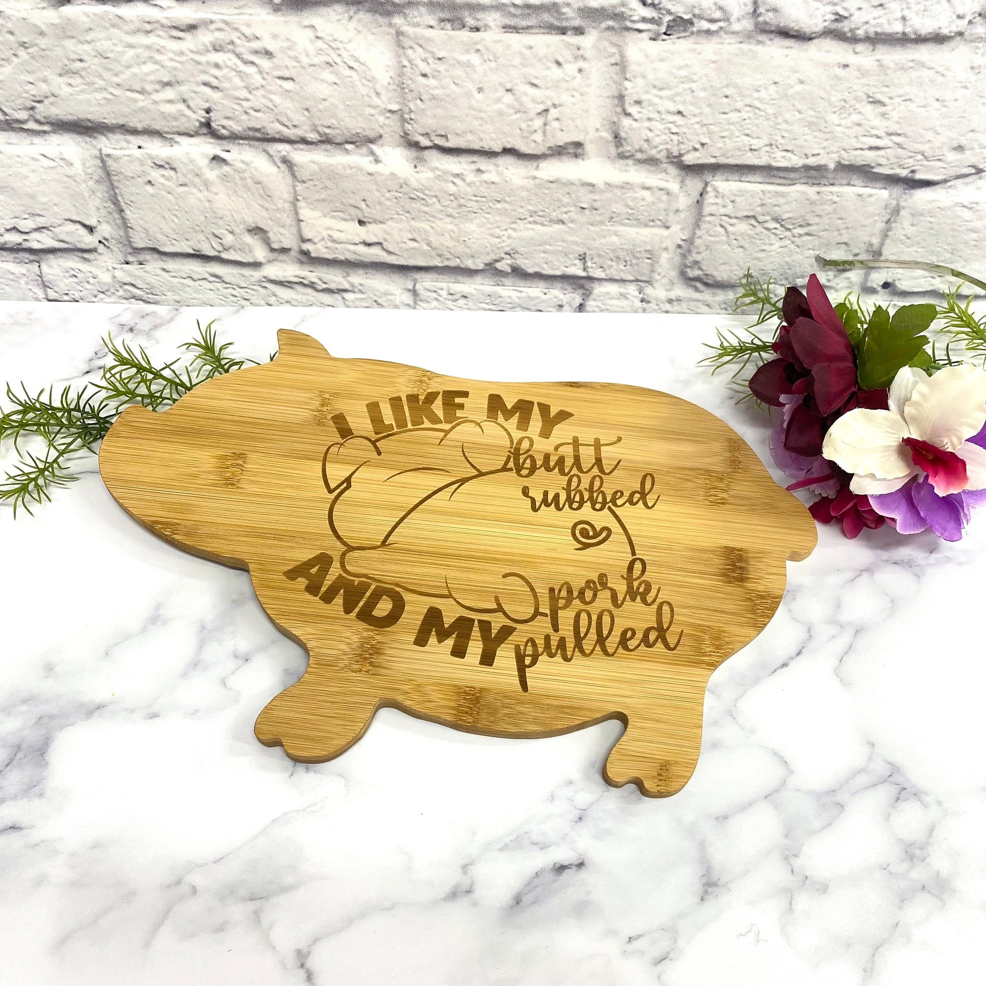 Personalized pig cutting board with custom text, resting on a white surface, ready for gifting.