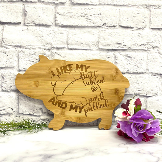 Laser engraved personalized pig bamboo cutting board, shown upright against a light background.