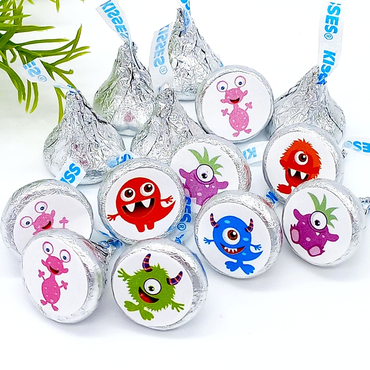 Cute monster candy labels sized to fit kisses candy, styled on a blue birthday background.
