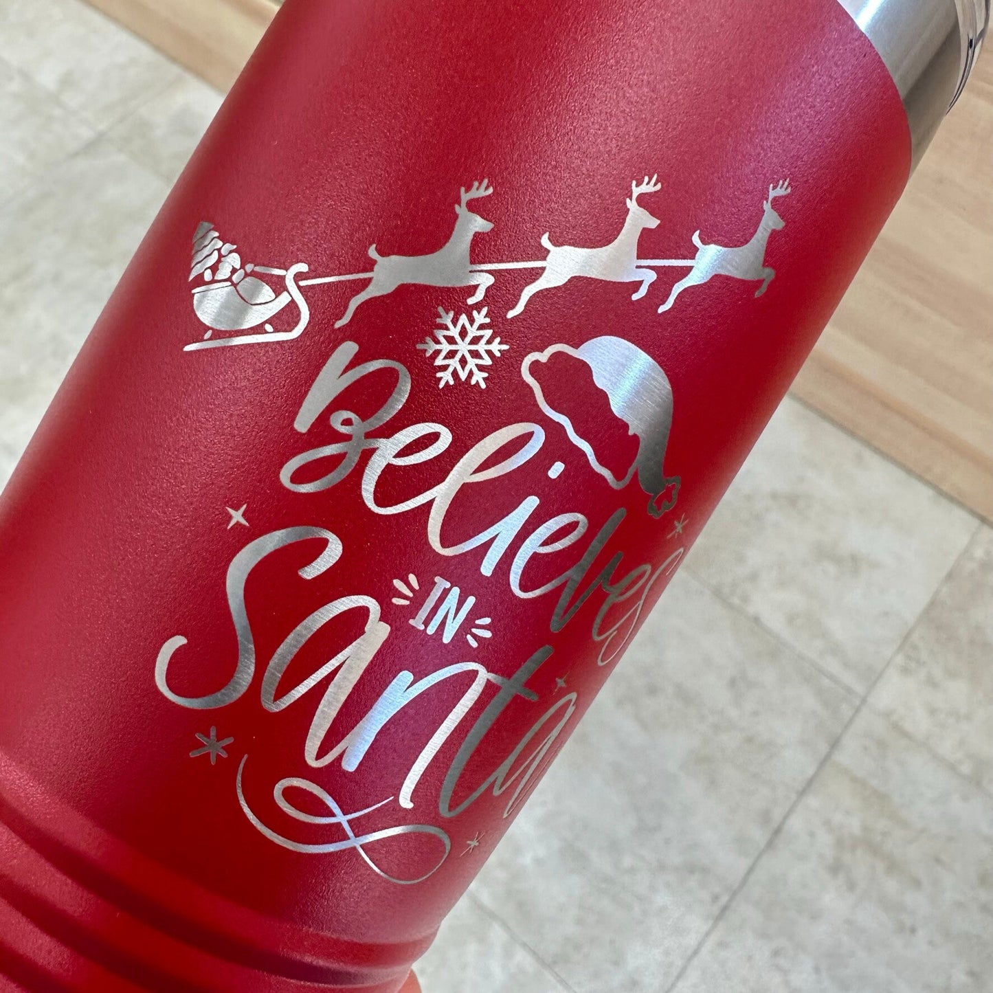 Group of three red 'Believes in Santa' tumblers, showcasing the festive personalized design and durable stainless steel.