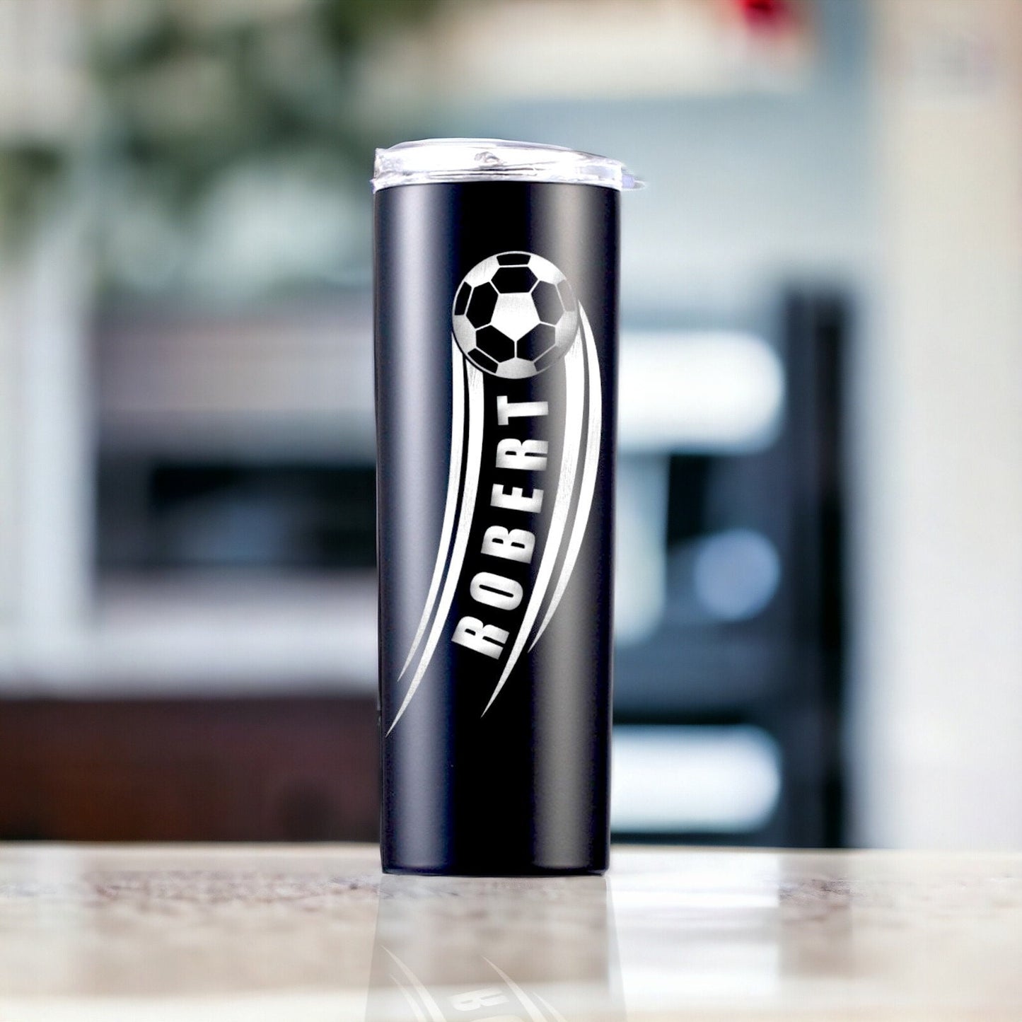 Stainless steel personalized soccer gift tumbler from an angle, highlighting the laser engraving and clear lid with straw.