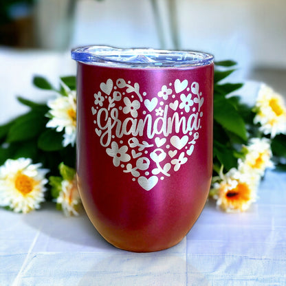 Textured shot of a pink 12oz stainless steel tumbler with "Grandma" and a floral heart design, ready for gifting.