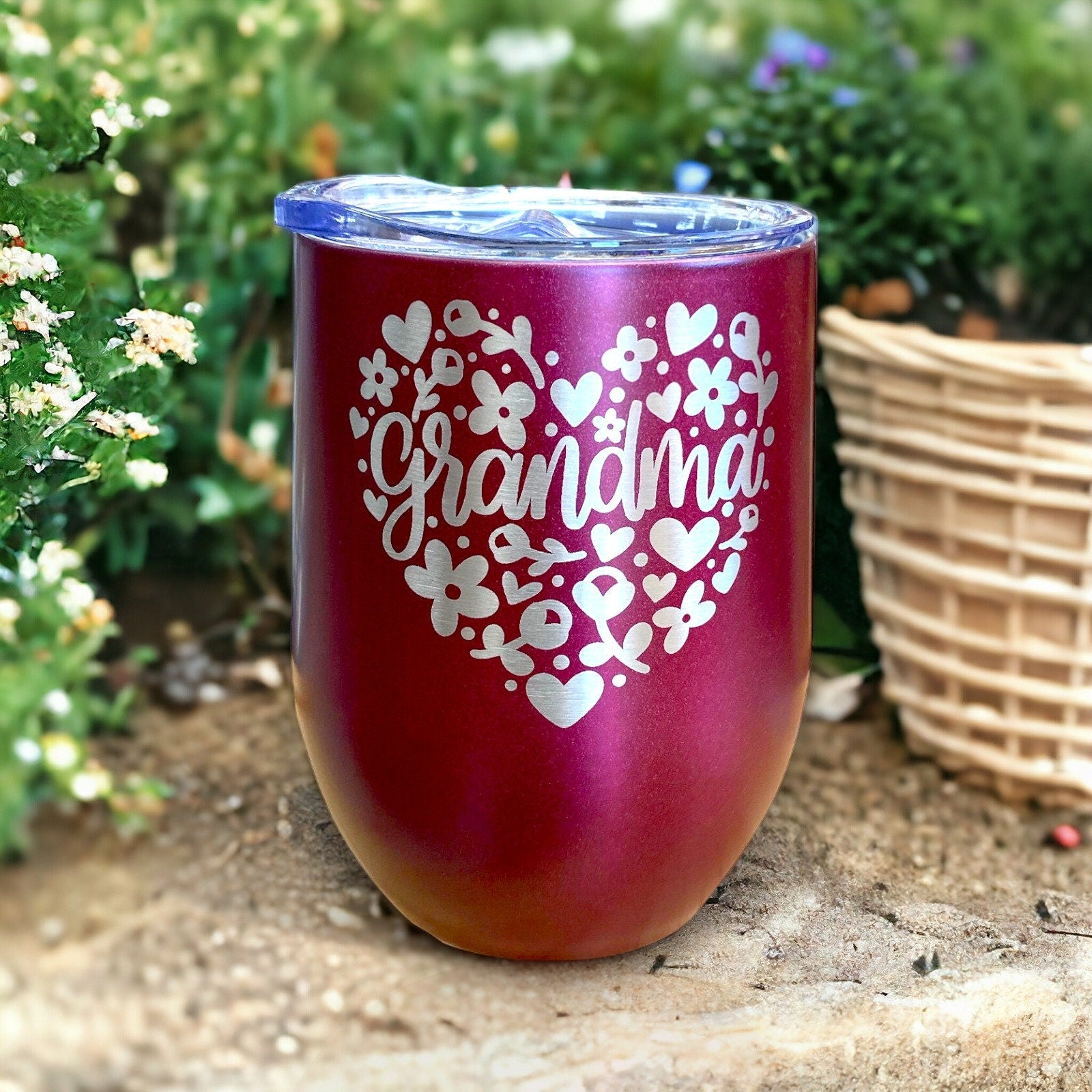 Floral heart design tumbler in pink for grandmas, with the personalized engraving clearly visible in detail.
