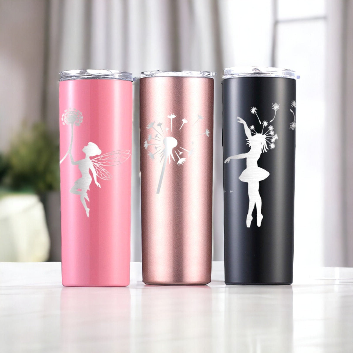 Assorted fairy tumblers in pink, rose, silver, and black showing the engraved design range.