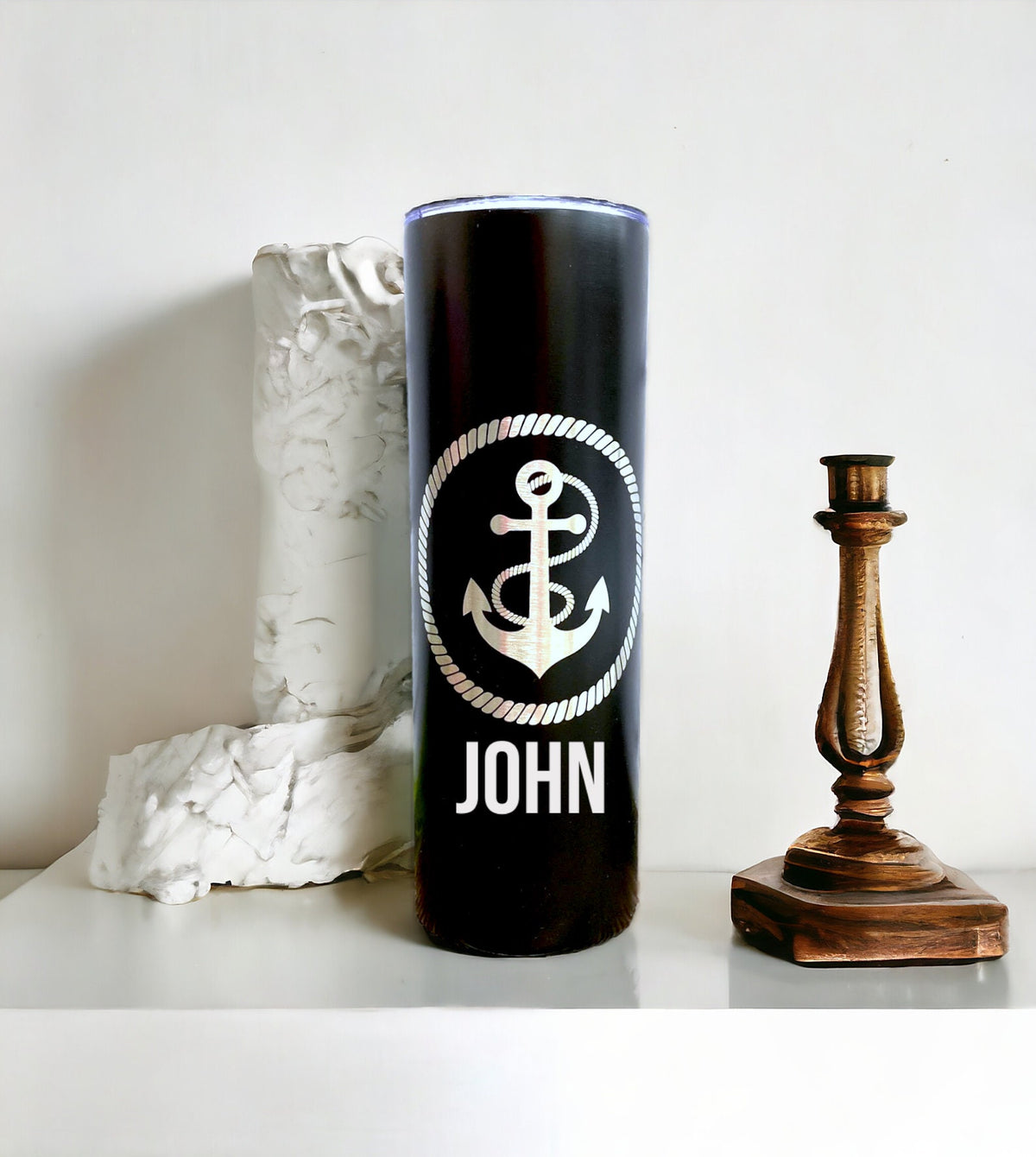 A personalized anchor cup styled with beach and cruise-themed accessories.