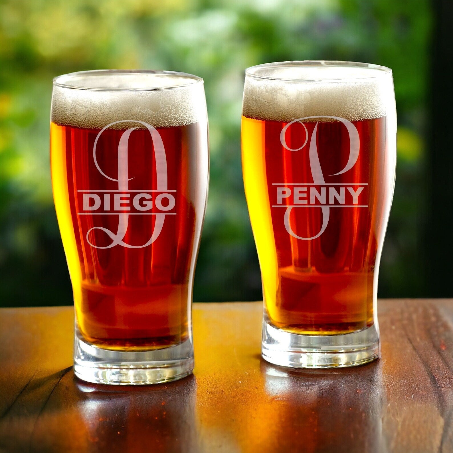 A custom beer glass with a visible laser-etched design, demonstrating its clarity and durable finish.