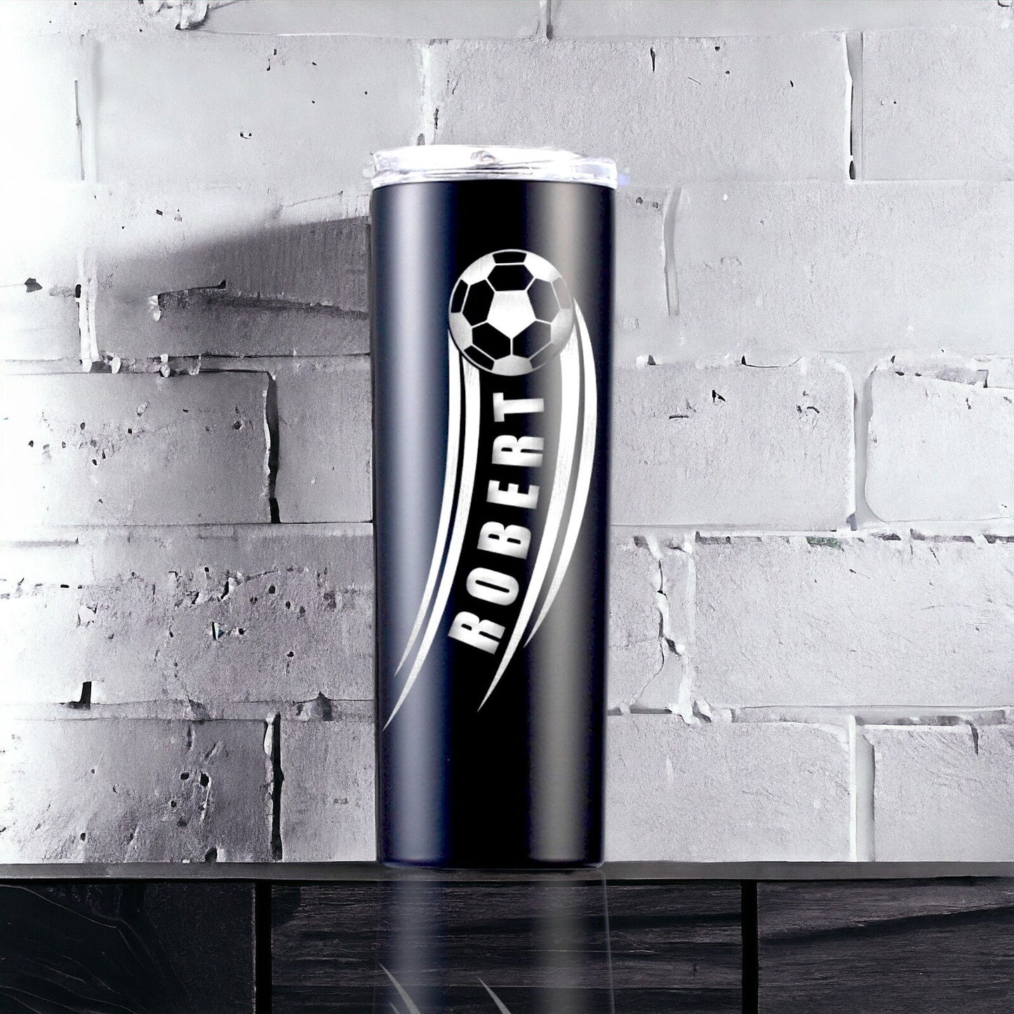 Lifestyle image of the personalized soccer gift tumbler on a field sideline, ready for use during a game.