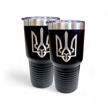 Pair of black 30 oz travel mugs with silver Ukrainian Tryzub emblems and clear lids on a white background.