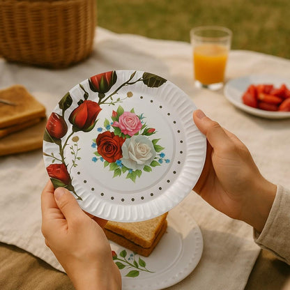 Several rose garden paper dessert plates arranged on a table, ready for a tea party or spring celebration.