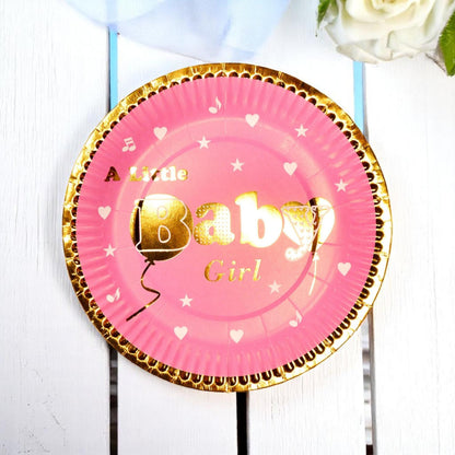 Arrangement of assorted gold foil baby shower plates in blue and pink, showcasing decorative details.