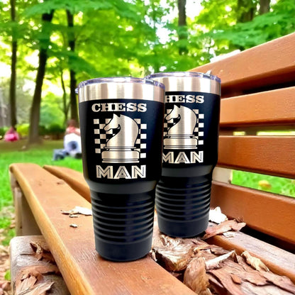 A 30 oz laser engraved chess tumbler placed on a wooden chess board, emphasizing its theme and use.