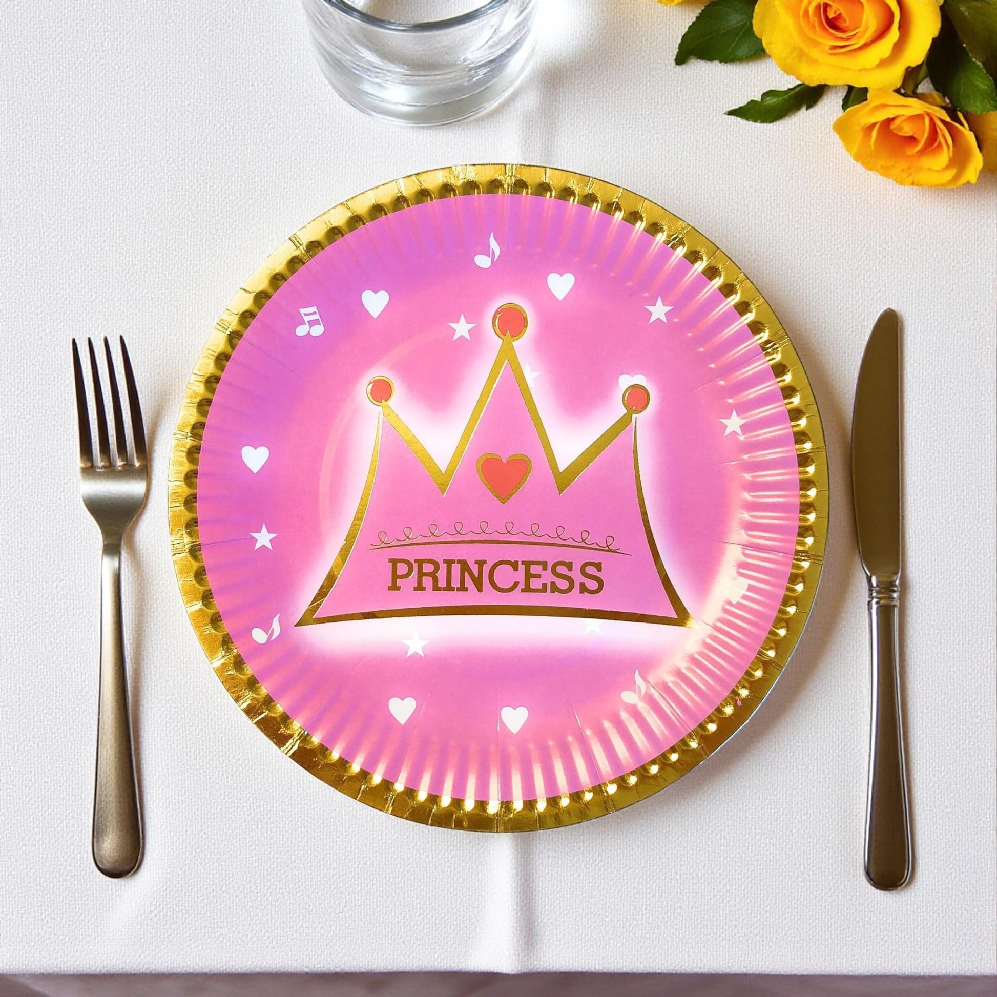 Close-up of a single 7-inch pink paper dessert plate with a glittery gold crown and star details.