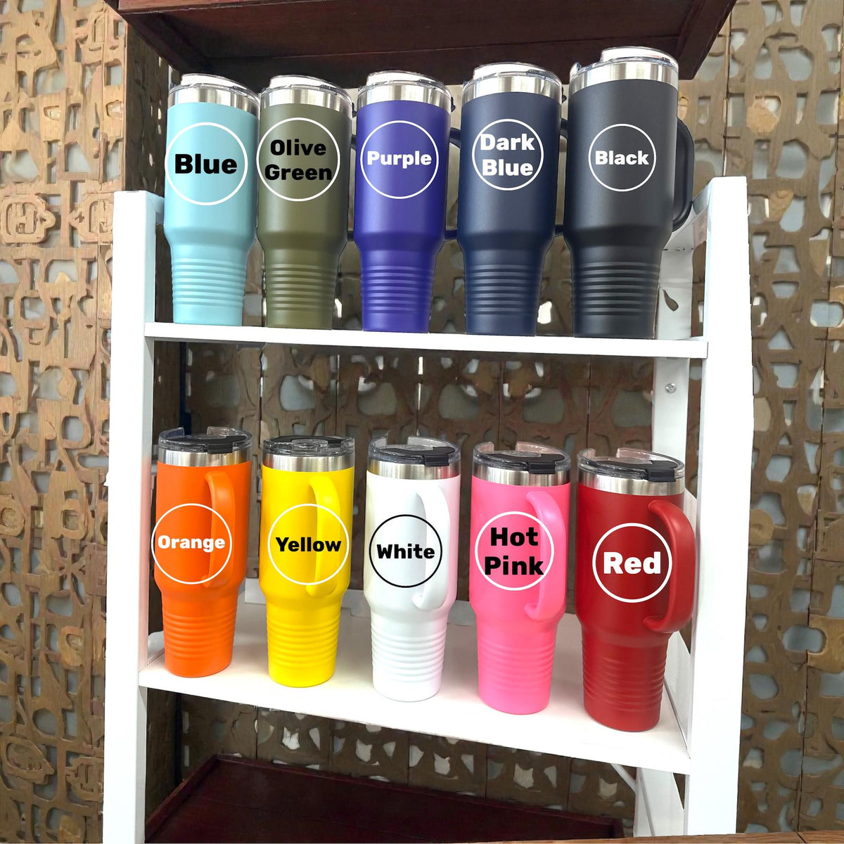 Close-up of a pink personalized nail salon tumbler with a handle, showcasing the custom engraved name and polish design.