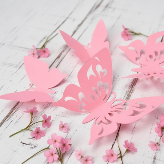 Set of 12 pink 3D cardstock butterflies, fanned out to show varying sizes and delicate details for wall decor.