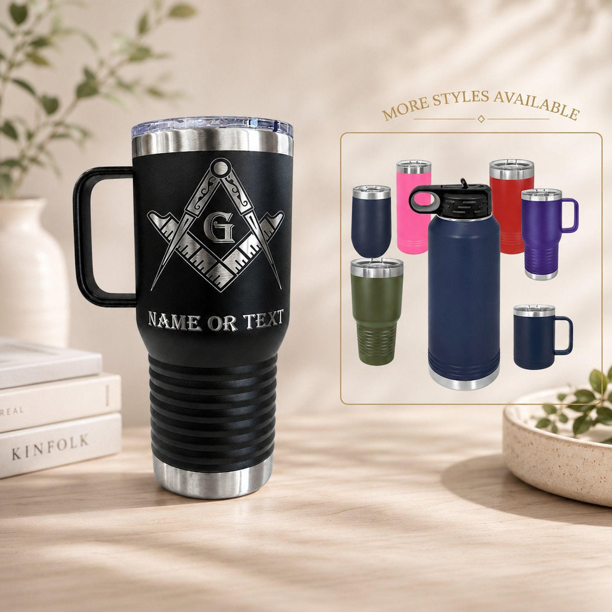 Freemason tumbler in stainless steel, shown in a natural setting on a dark wood desk with a book.