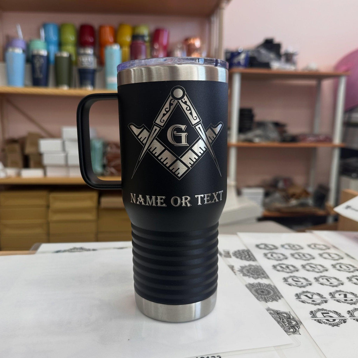 Hand holding a masonic emblem tumbler, highlighting its ergonomic shape and secure grip for daily use.