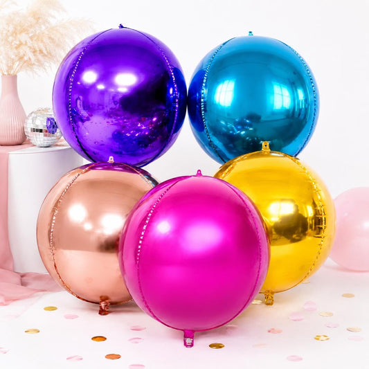 foil shiny round mylar foil balloons in rose gold, floating together against a light background.