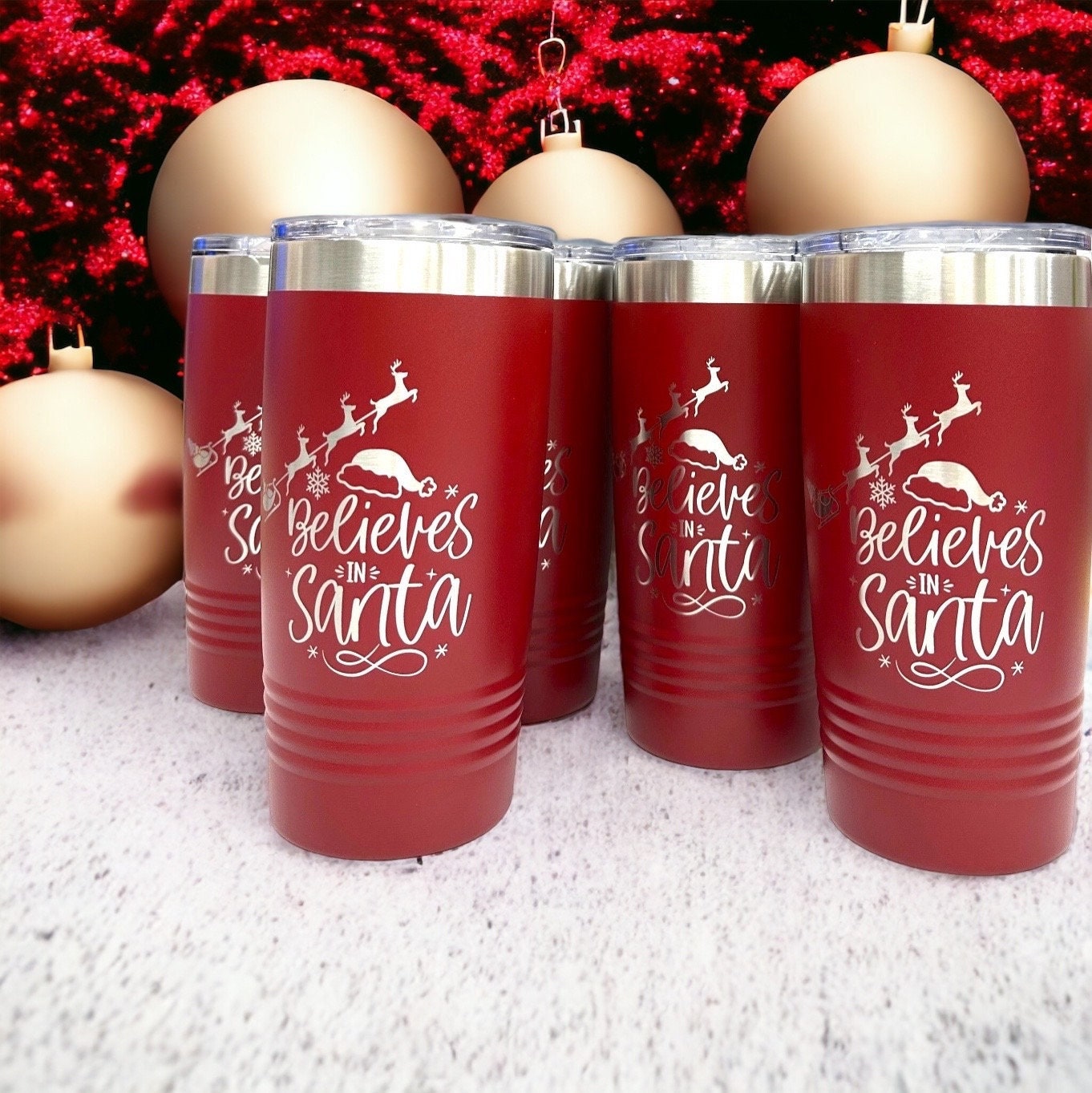 Angled view of the red stainless steel tumbler, showing the secure lid and festive Christmas reindeer design.