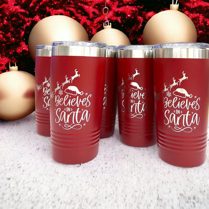 Angled view of the red stainless steel tumbler, showing the secure lid and festive Christmas reindeer design.