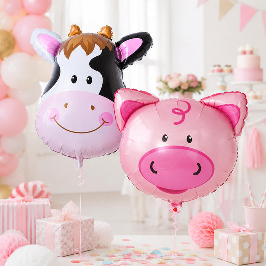 Two large foil balloons, one pink pig and one spotted cow, for a farm-themed party.