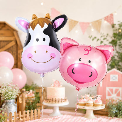 Close-up of the giant cow foil balloon, with black and white spots, for a baby shower.