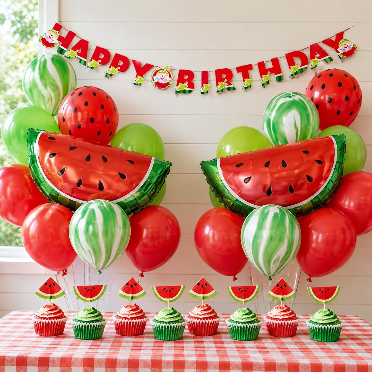 Complete watermelon first birthday party kit, featuring balloons, 'Happy Birthday' banner, and cupcake toppers arranged for a festive display.