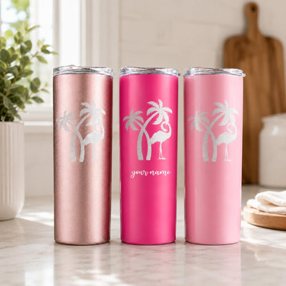Rose gold, hot pink, and pastel pink tropical tumblers with silver flamingo designs in a bright kitchen.