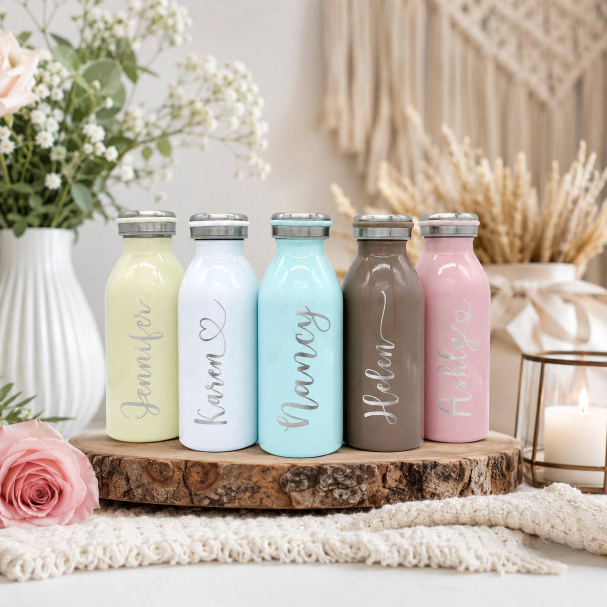 Pastel water bottle in white, featuring a custom name laser-engraved on the side.
