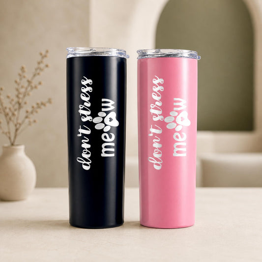 Black and pink cat lover tumblers on a neutral table with vertical Don't Stress Meow engraving.