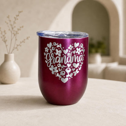 Pink 12oz stainless steel grandma floral heart tumbler with a clear lid, displayed on a clean background.