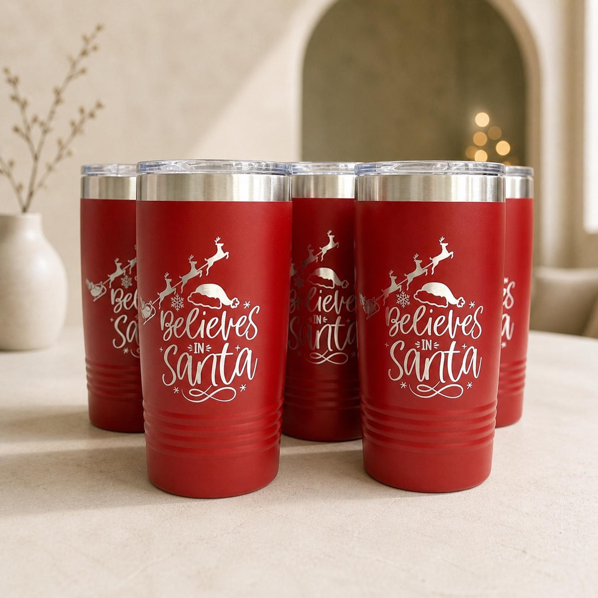 Customizable red stainless steel Christmas tumbler with "Believes in Santa" and reindeer laser engraving, 20oz.