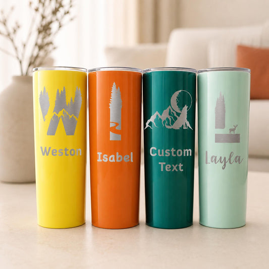 Four personalized camping tumblers in yellow, orange, green and mint with mountain initial name engravings.