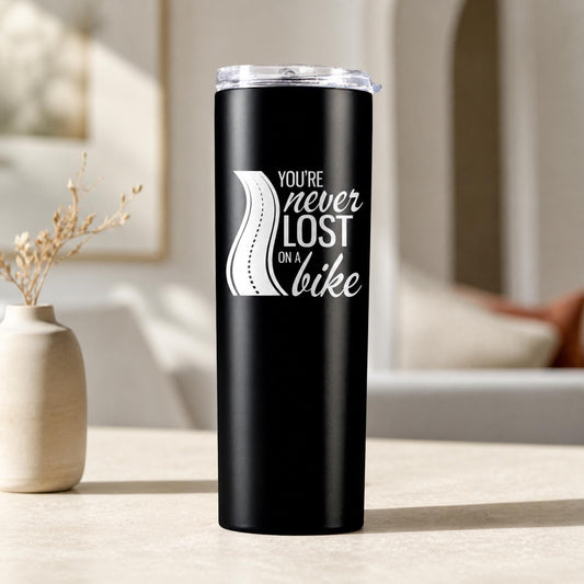 Black personalized motorcycle travel mug with white road quote and clear lid on a neutral table