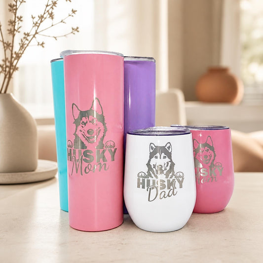 Personalized husky tumbler group in pink, aqua, purple, and white with Husky Mom and Dad engravings.