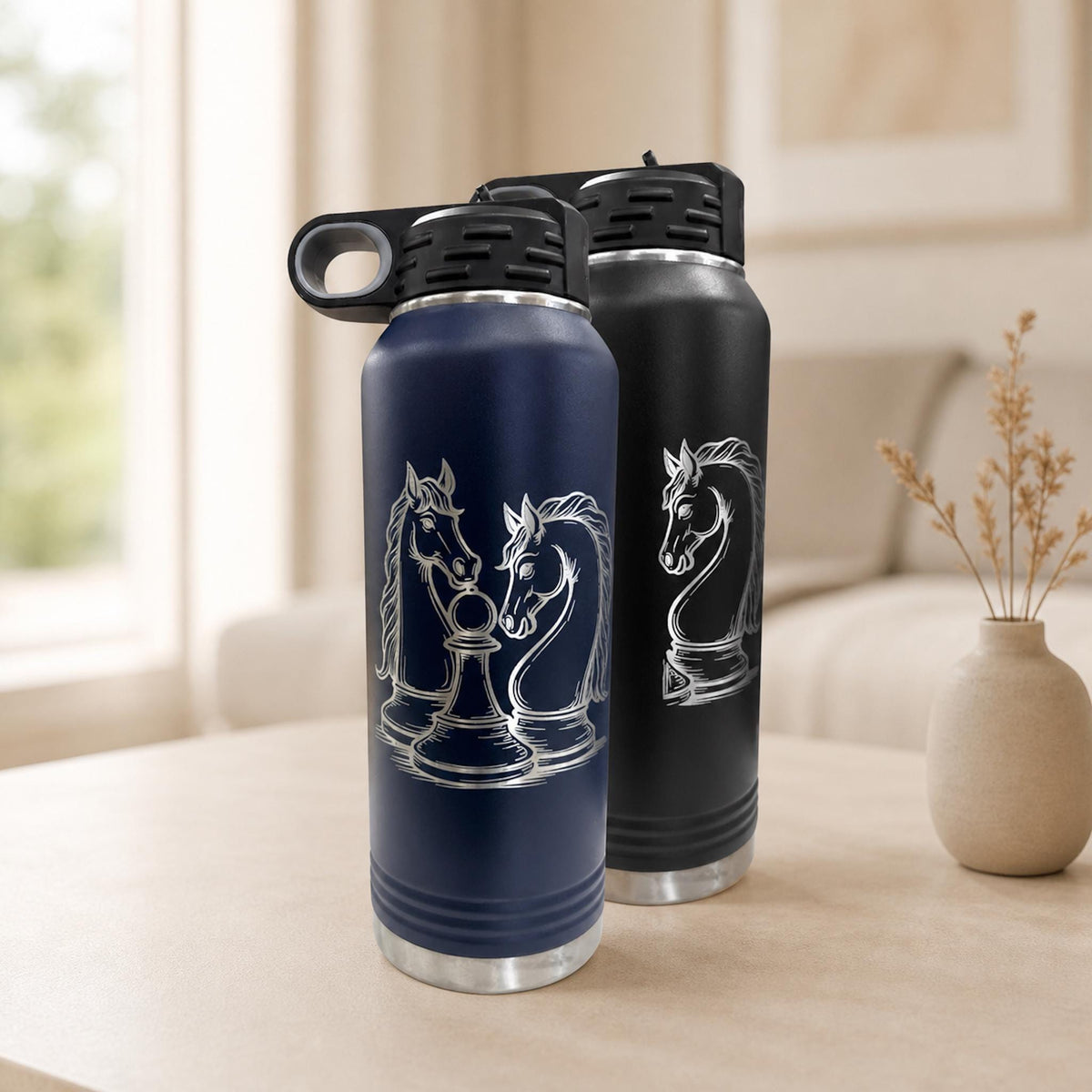 Navy and black 32 oz chess water bottles with knight-and-pawn engraving on a neutral table.