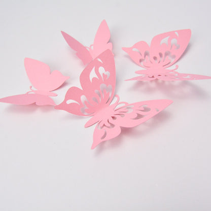 Overhead view of multiple pink cardstock butterflies, illustrating the different sizes and shapes for custom room decor.