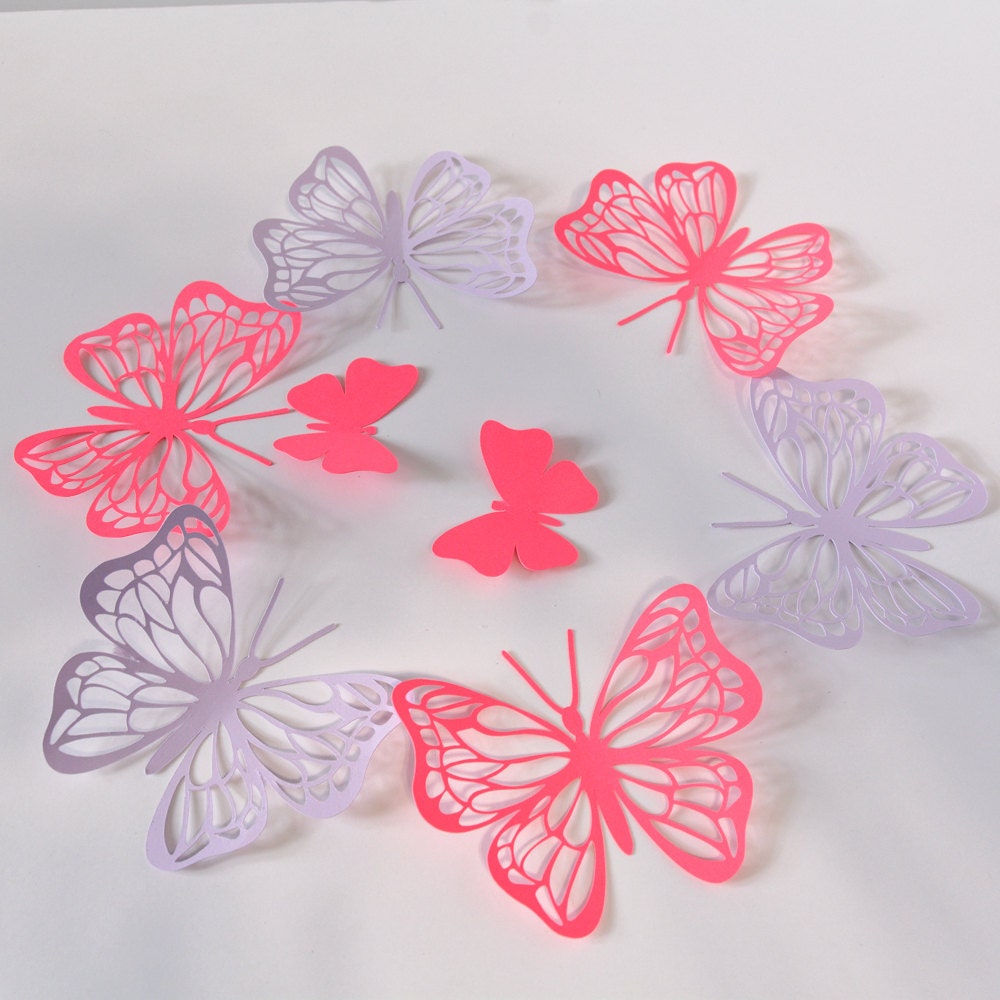 Close-up of butterfly wall decals in two sizes, cut from cardstock paper with adhesive tabs